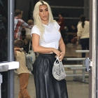 Kim Kardashian gives a peek at her tiny waist in crop top and Balenciaga leather pants as she joins ex-husband Kanye West and sister Khloe at son Saint's basketball game in LA