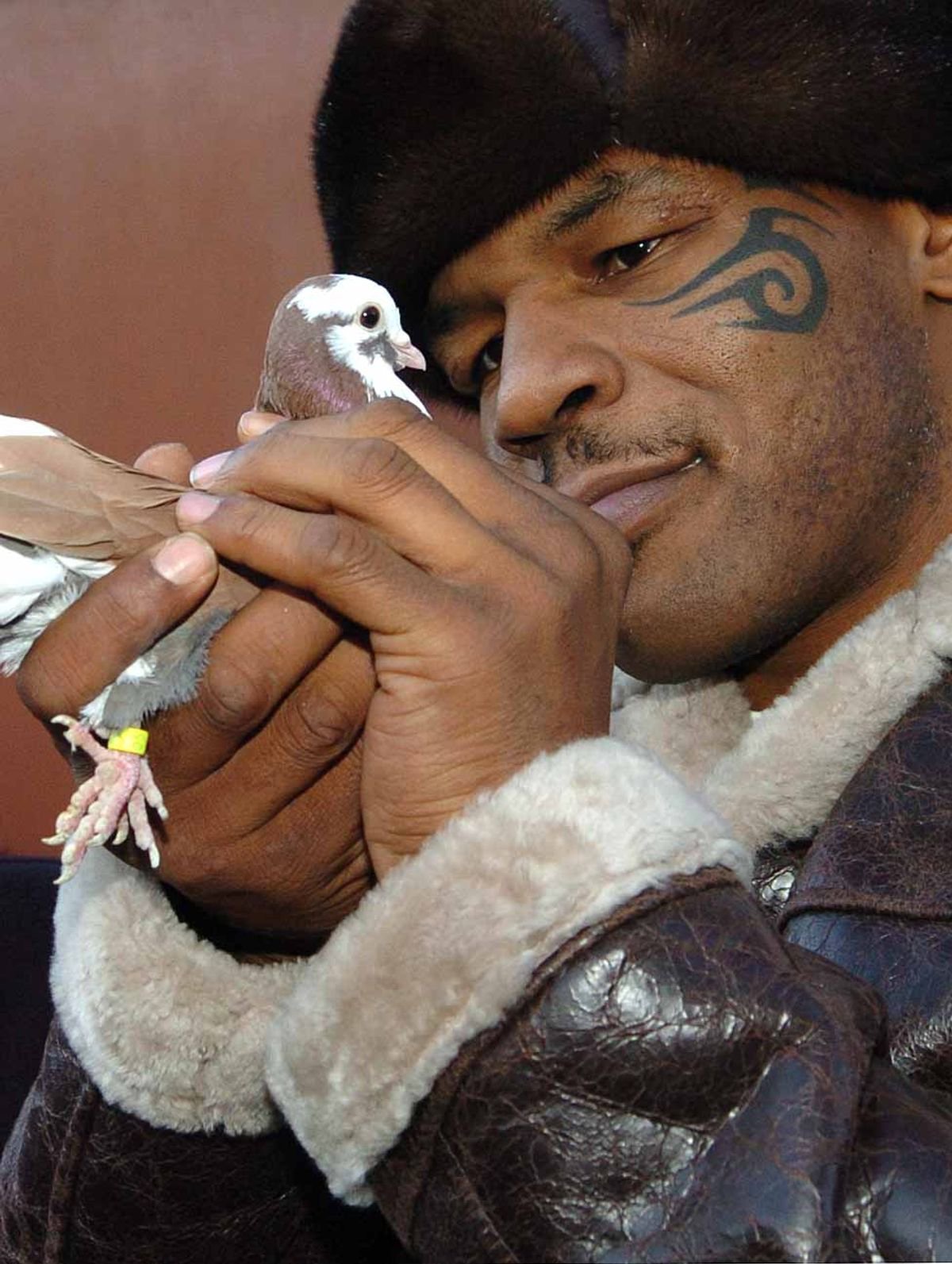 Tyson shows his gentler side when he visited the home of pigeon fancier Horace Potts i