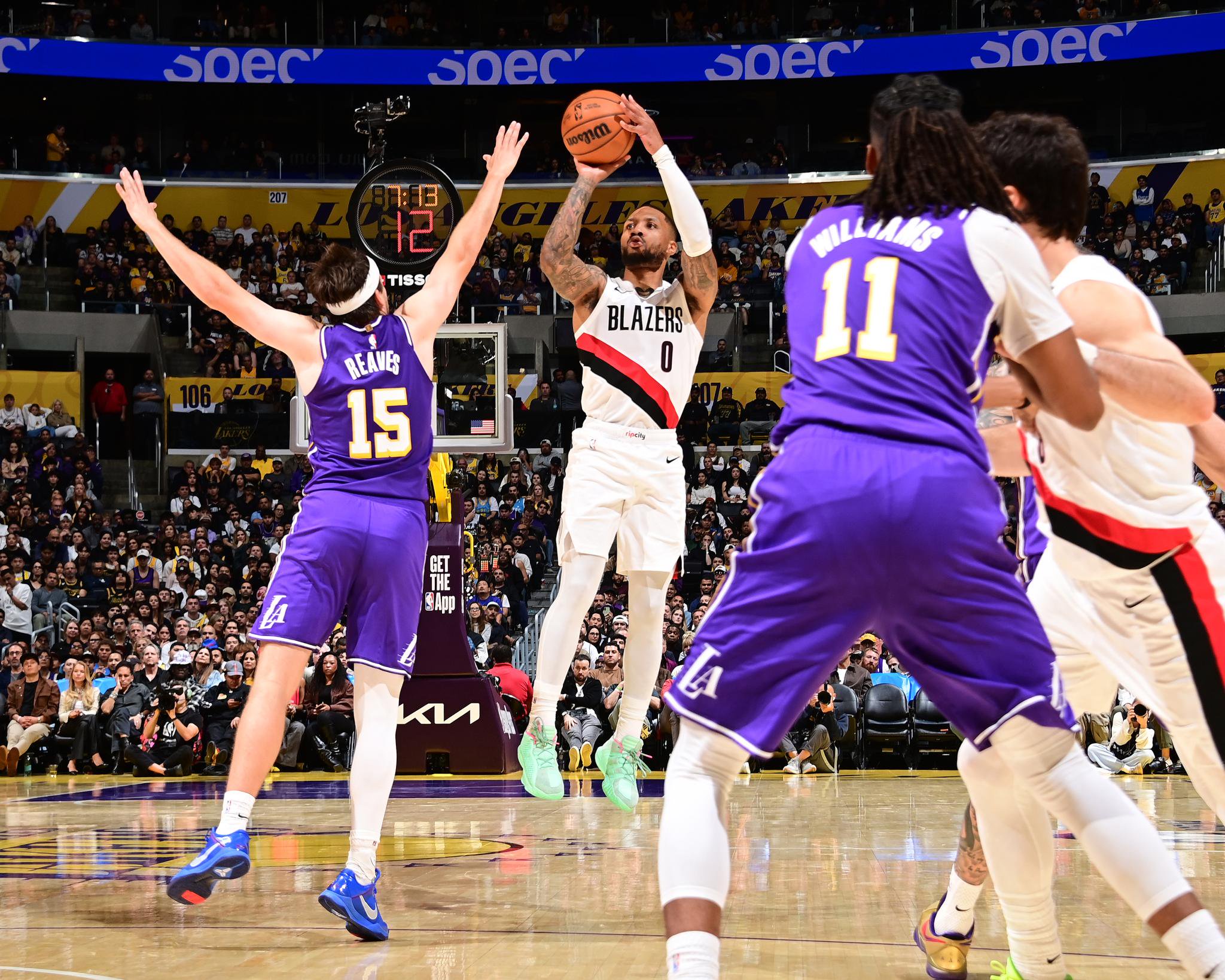 Portland Trail Blazers' Damian Lillard (0) shoots a 3-point basket during a game against the Los Angeles Lakers.
