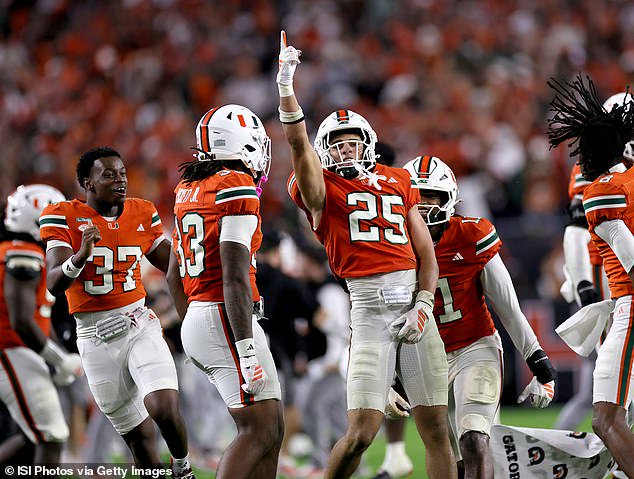 JJ Dunningham celebrates with his Miami Hurricanes teammates after an INT vs Florida State