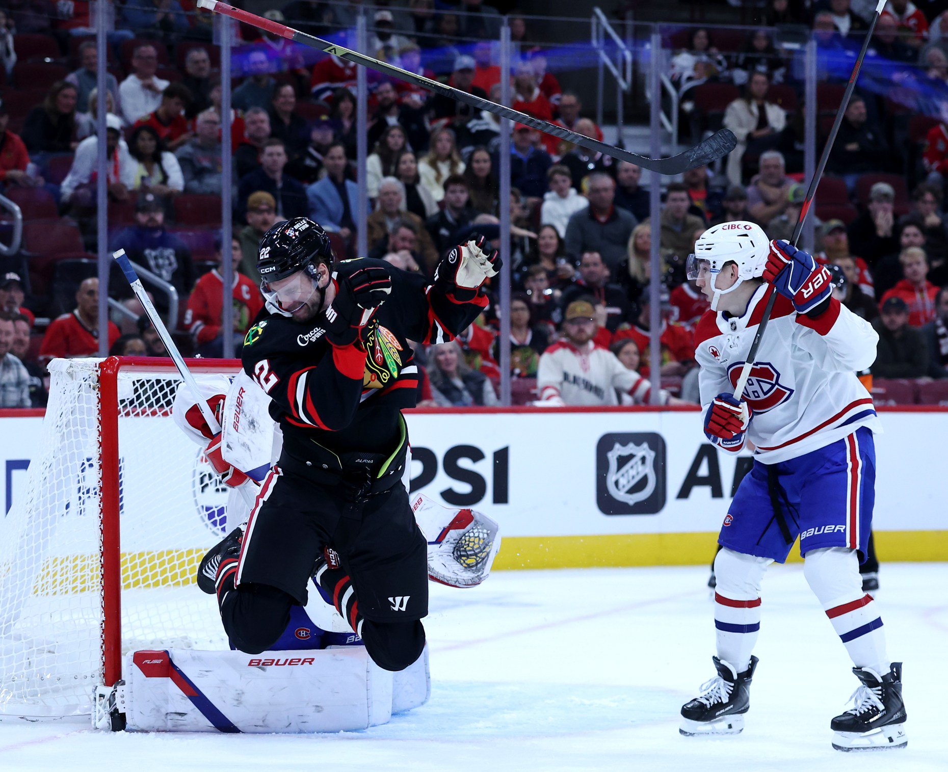 Chicago Blackhawks right wing Cole Smith (22) reacts after being hit in the face with a puck in the third period of a game against the Montréal Canadiens at the United Center in Chicago on Oct. 23, 2026. (Chris Sweda/Chicago Tribune)