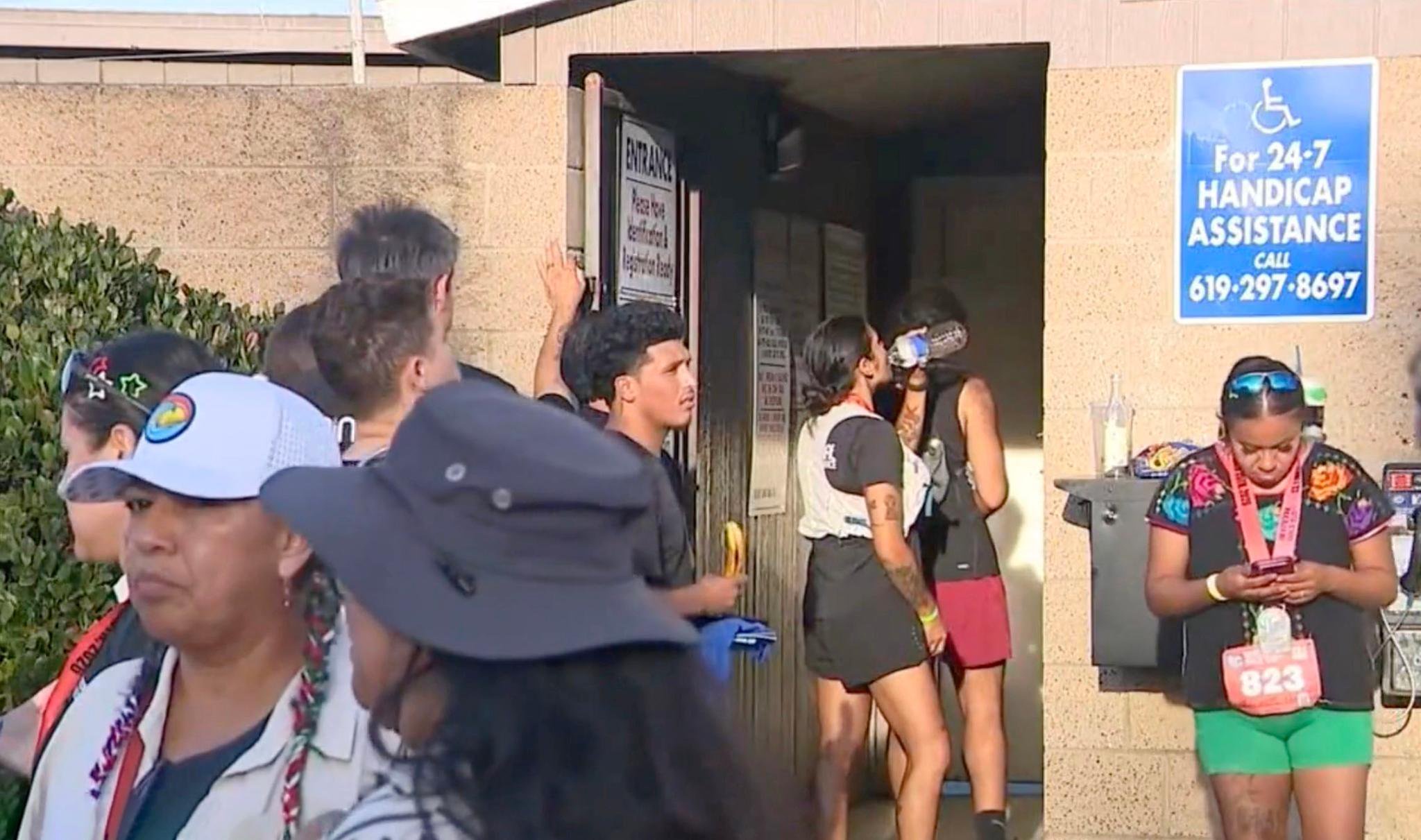 Runners gather outside a building following the Binational Race.