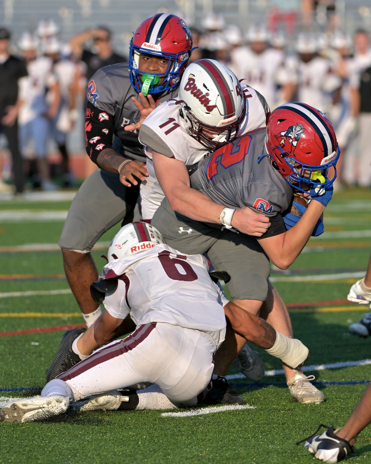 Broadneck Bruins Grayson Boone #11 and Dominic Montgomery #6 stop Old Mill Patriots Tyler McConville #22 on a run in the second quarter. The Old Mill Patriots host the visiting Broadneck Bruins in high school football at the Severn Run High School. (Paul W. Gillespie/Staff)