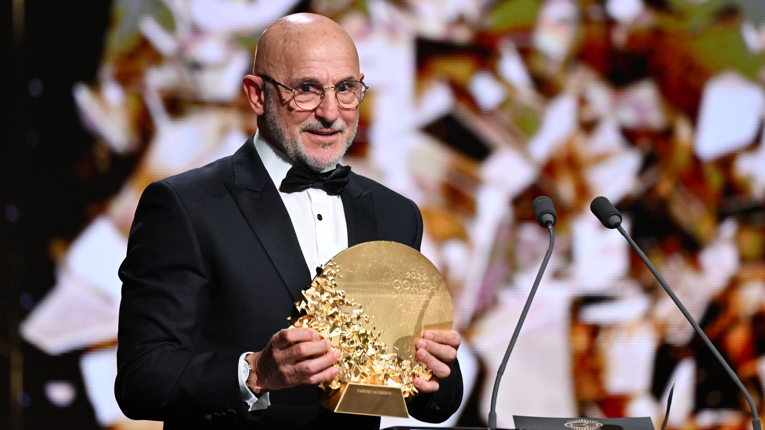 Image may contain Gold Adult Person Accessories Formal Wear Tie Head Face Glasses and People