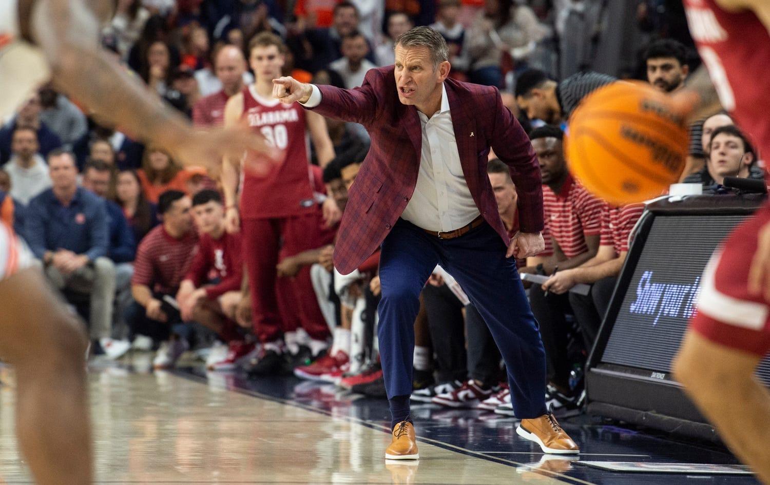 Alabama Crimson Tide head coach Nate Oats talks with his team from the sideline as Auburn Tigers take on Alabama Crimson Tide at Neville Arena in Auburn, Ala., on Saturday, Feb. 11, 2023.