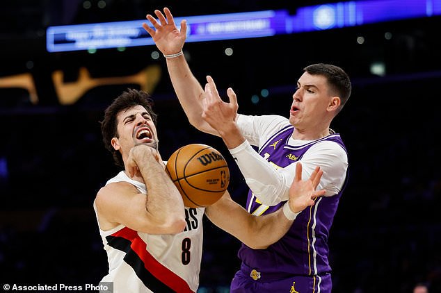 Portland Trail Blazers forward Deni Avdija (8), left, loses control of the ball while being guarded by Los Angeles Lakers forward Jake LaRavia (12), right, during the first half of an NBA basketball game Tuesday, Oct. 27, 2026, in Los Angeles. (AP Photo/Caroline Brehman)