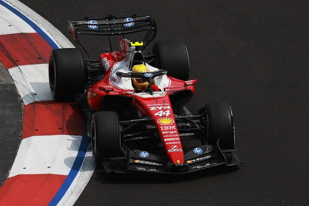 Formula 1 car #44 in red Ferrari livery with IBM and Shell logos taking a corner at the Mexican GP, driver in yellow helmet