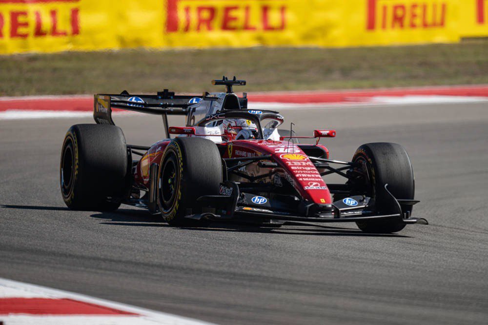 Ferrari Formula 1 car on track at COTA, with Pirelli tyres and red-and-white barriers, driven by a rider in a red helmet