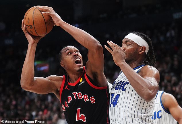 Toronto Raptors' Scottie Barnes (4) battles against Orlando Magic's Wendell Carter Jr. (34) during the first half of an NBA Cup basketball game in Toronto, Friday, Oct. 30, 2026. (Nathan Denette/The Canadian Press via AP)