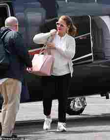 Melinda carried a pink Chanel bag and wore a mesh jacket, white blouse, black trousers, and Loewe sneakers