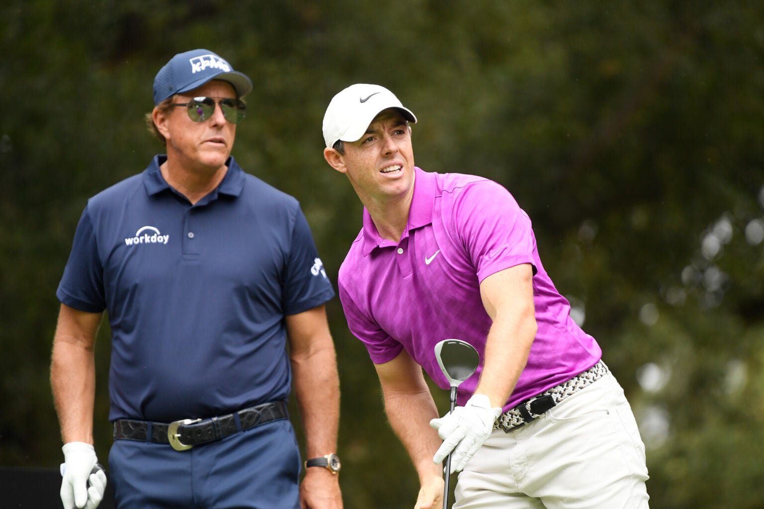 Rory McIlroy watches his shot from the sixth tee as Phil Mickelson of the United States looks on during the first round of the Zozo Championship