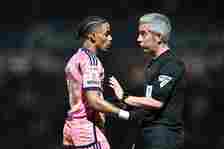 Crysencio Summerville of Leeds United and referee Darren Bond during the Sky Bet Championship match between Queens Park Rangers and Leeds United at...