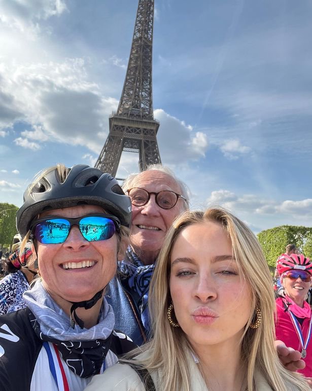 Louise and her family in front of the Eiffel tower