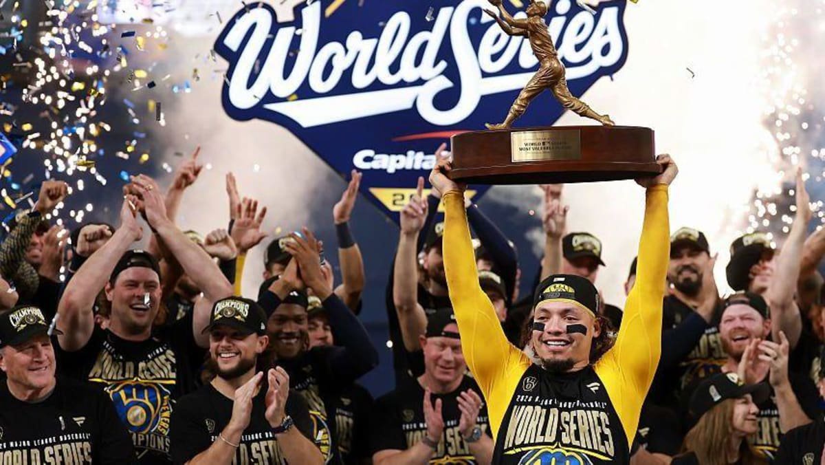 William Contreras lifts the Willie Mays World Series Most Valuable Player award after the Milwaukee Brewers beat the Tampa Bay Rays in game five to clinch the 2026 World Series