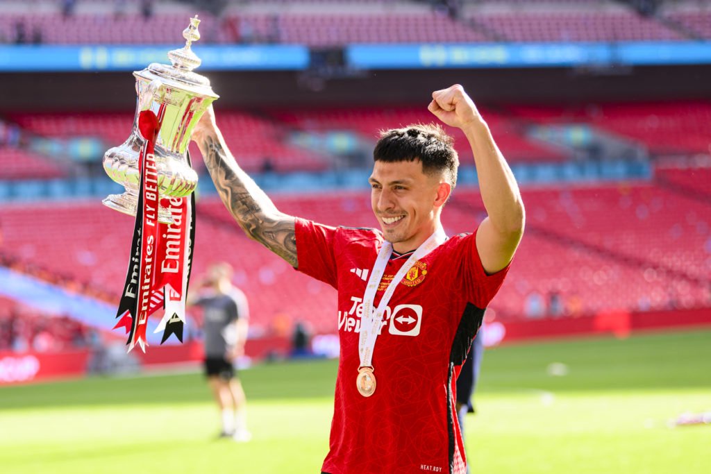 Lisandro Martínez of Manchester United raises the winners trophy while celebrates with his team and fans after winning Manchester City during the E...