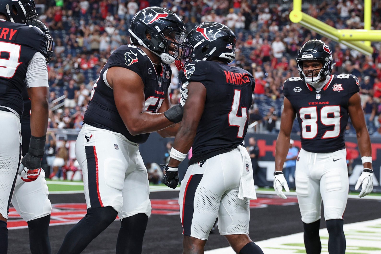Aug 20, 2026; Houston, Texas, USA;  Houston Texans running back Woody Marks (4) celebrates with Houston Texans guard Ed Ingram (69) after scoring a touchdown during the first quarter against the Las Vegas Raiders at Reliant Stadium. Mandatory Credit: Troy Taormina-Imagn Images