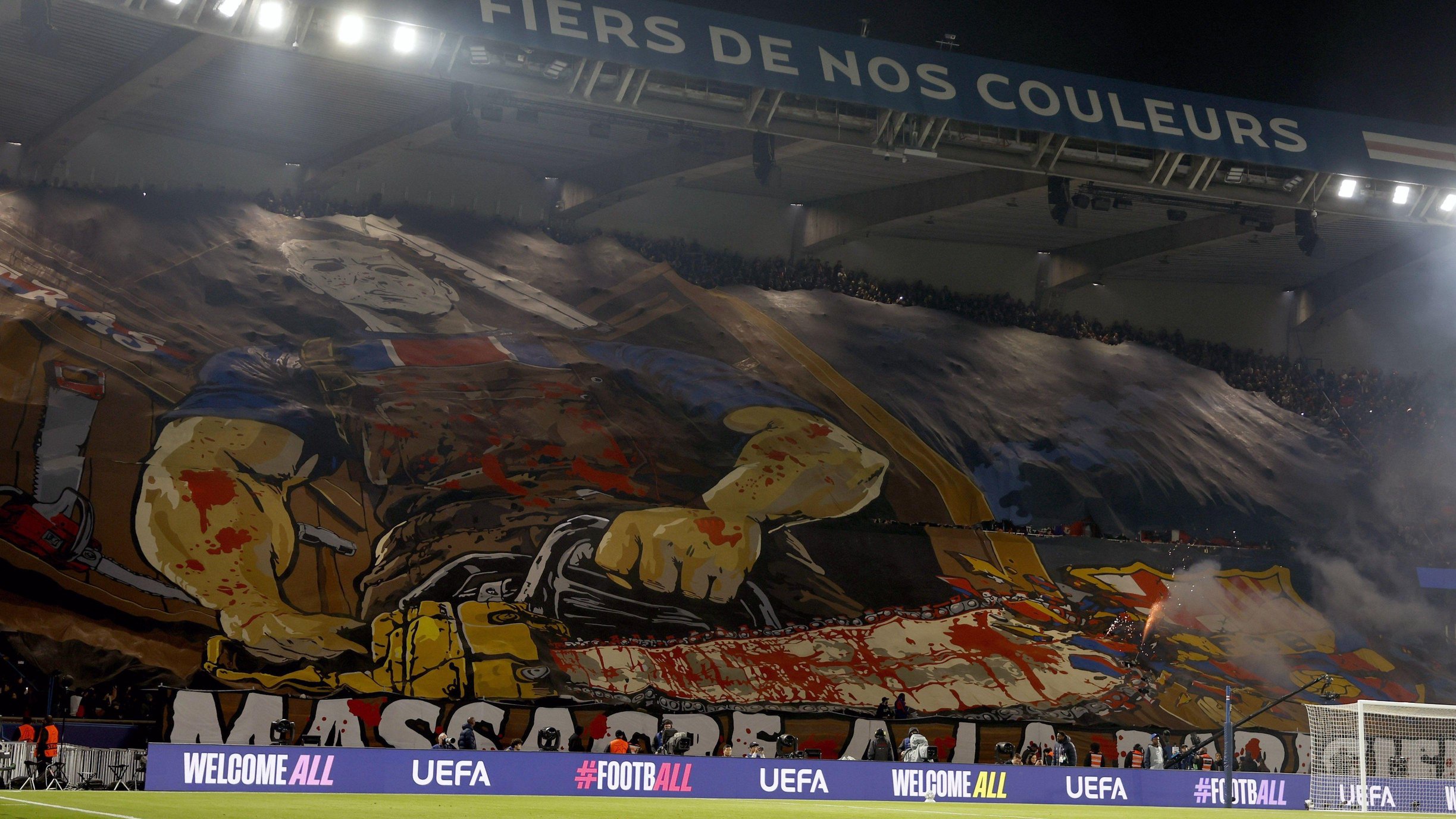 A colourful banner featuring a man holding a bloody chainsaw