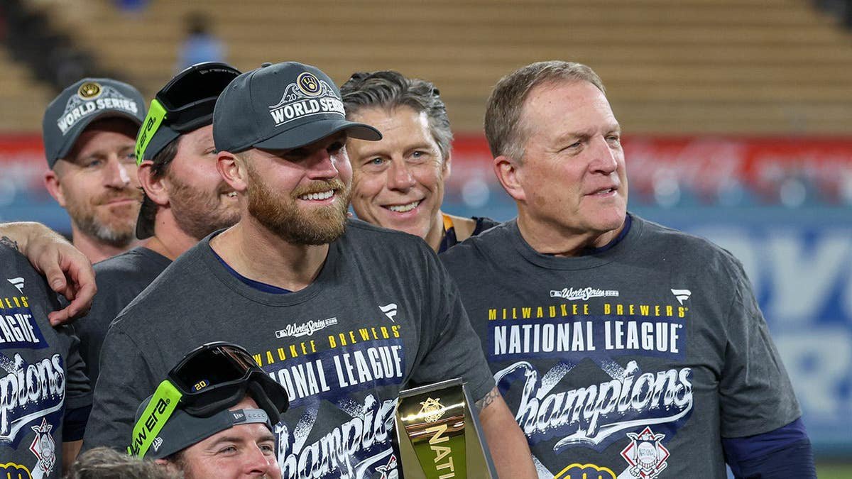 Milwaukee Brewers members pose for a group photo on the field at Dodger Stadium.