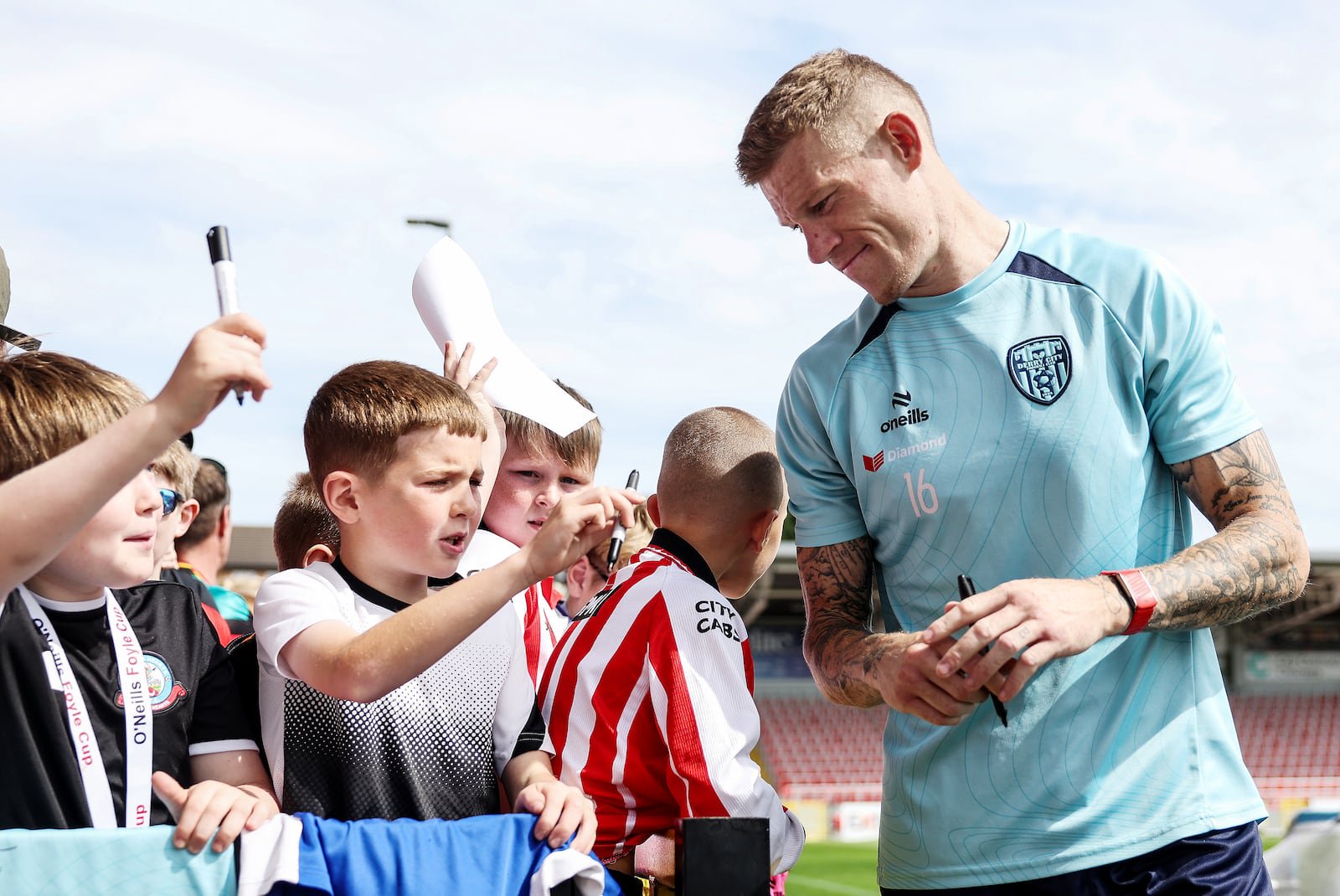Derry City's James McClean signs autographs for young fans at an open training session in the Brandywell in August. Photograph: Jonathan Porter/Inpho