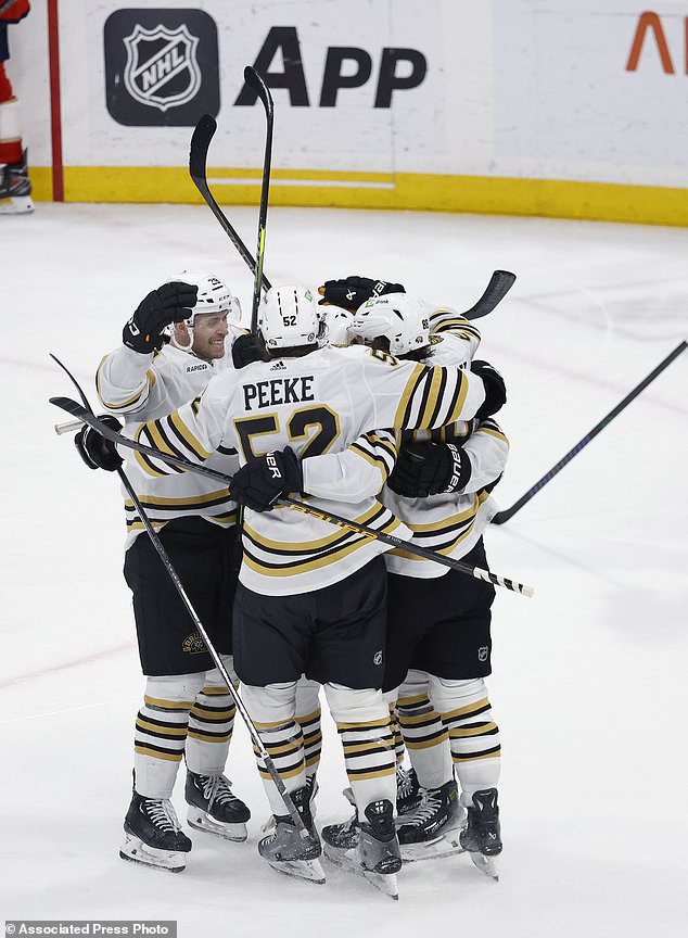 The Boston Bruins celebrate their goal against the Florida Panthers during the third period of an NHL hockey game, Tuesday, March 26, 2024, in Sunrise, Fla. (AP Photo/Rhona Wise)