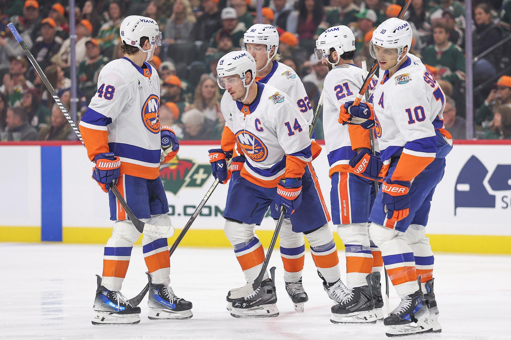 New York Islanders players celebrate a goal against the Minnesota Wild.
