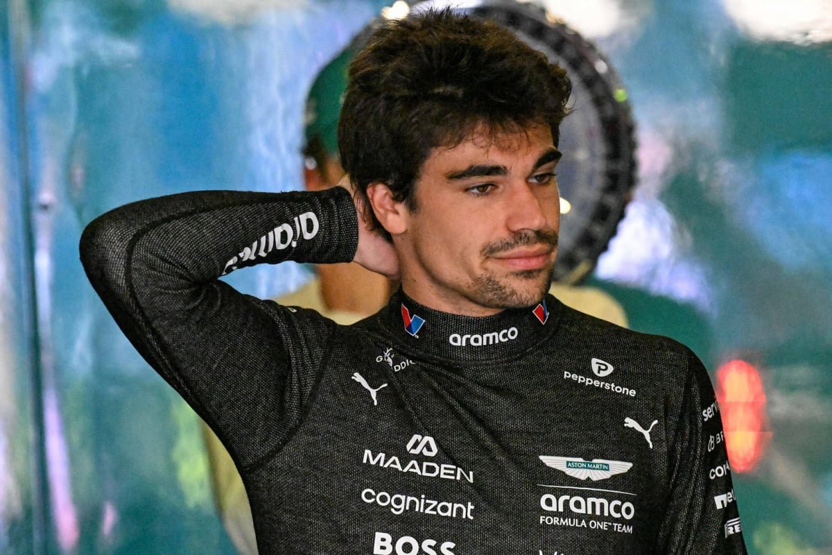 Lance Stroll looks crestfallen at the back of the Aston Martin garage — Photo: © IMAGO
