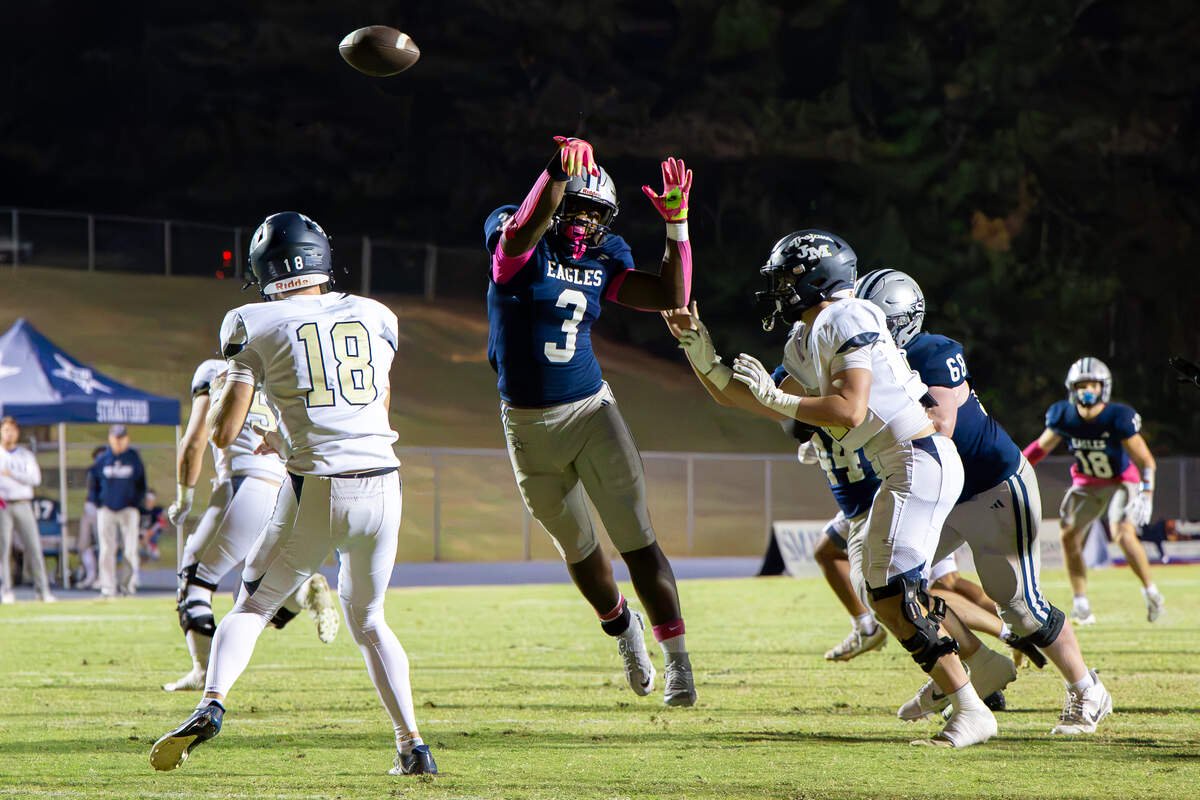 Senior Myles Cobb (3) bats away a pass attempt by Nathan Snow (18) as Stratford falls to John Milledge Academy 20-28.