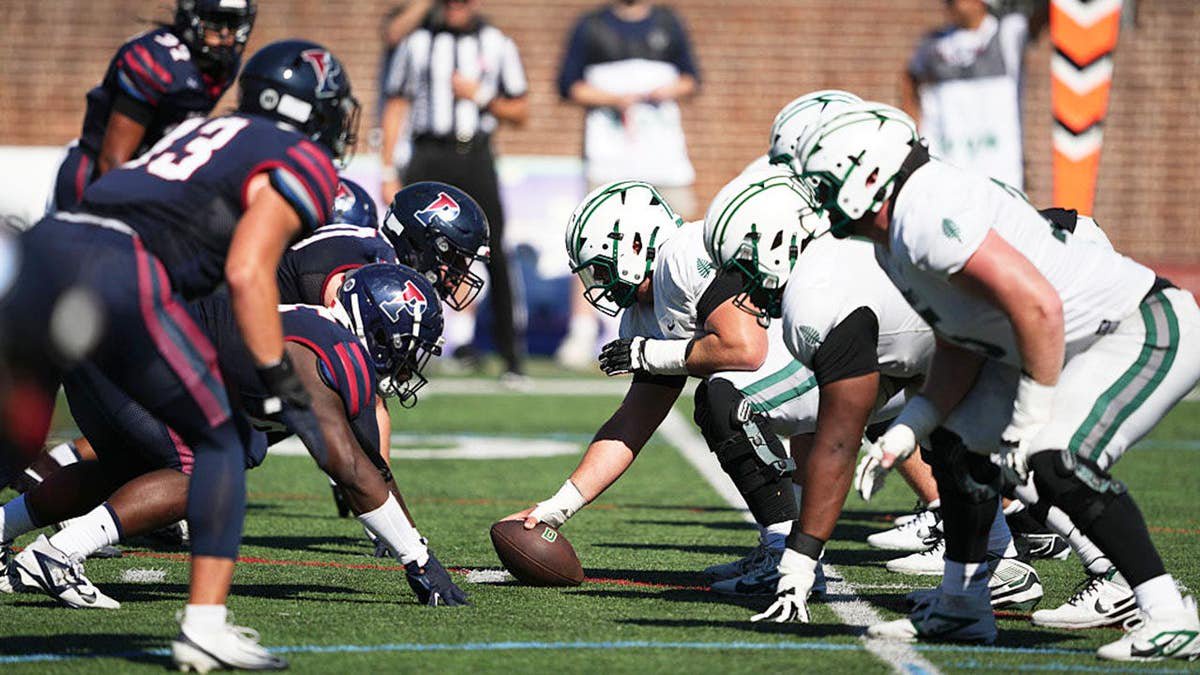 Penn Quakers face off with Dartmouth Big Green players during a game at Franklin Field.