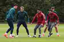 Mikel Arteta, Manager of Arsenal, participates in a training session alongside his players Kai Havertz and Martin Odegaard at London Colney on Apri...