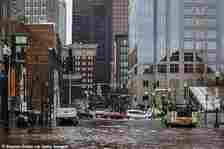 Older coastal cities like New York City, Boston and Philadelphia could be ‘inundated’ by untreated sewage flooding into streets and basements. Pictured: Boston residents experienced coastal flooding during heavy rainfall in January 2024