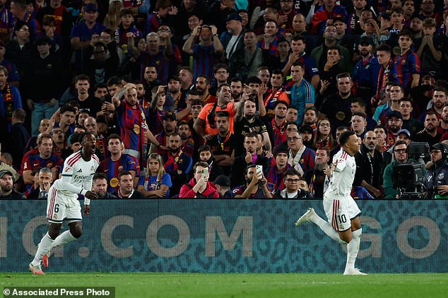 Real Madrid's Kylian Mbappe, right, celebrates after scoring his side's second goal during a Spanish La Liga soccer match between FC Barcelona and Real Madrid in Barcelona, Spain, Sunday, Oct. 25, 2026. (AP Photo/Joan Monfort)