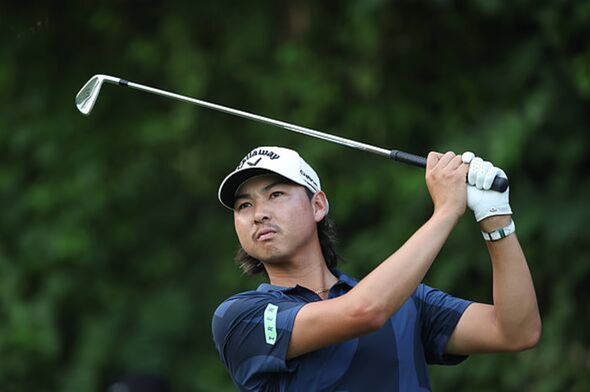 Min Woo Lee hits an iron shot