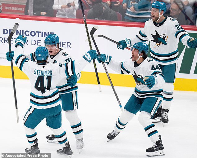 San Jose Sharks' Macklin Celebrini (71), second from left, celebrates his game-winning goal over the Montreal Canadiens with teammates Ivar Stenberg (41), Kiefer Sherwood (44) and Barclay Goodrow (23) during overtime in an NHL hockey game in Montreal, Tuesday, Oct. 20, 2026. (Christinne Muschi/The Canadian Press via AP)