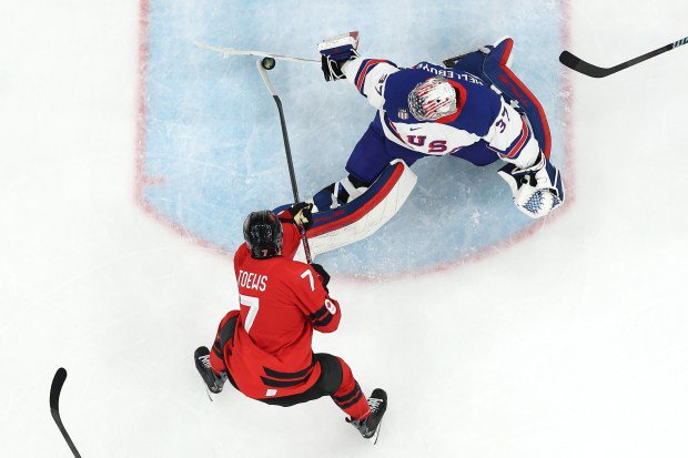 MILAN, ITALY - FEBRUARY 22: (EDITOR'S NOTE: Image was captured using a remote camera positioned above the field of play.) Connor Hellebuyck #37 of Team United States saves the shot taken by Devon Toews #7 of Team Canada in the third period during the Men's Gold Medal match between Canada and the United States on day 16 of the Milano Cortina 2026 Winter Olympic games at Milano Santagiulia Ice Hockey Arena on February 22, 2026 in Milan, Italy. (Photo by Jared C. Tilton/Getty Images)