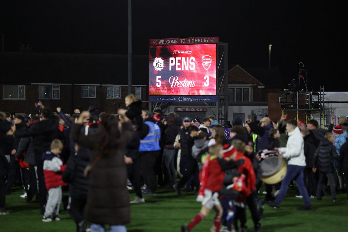 Fleetwood fans invade the pitch as they celebrate winning the English League Cup fourth round football match between Fleetwood Town and Arsenal at Highbury Stadium