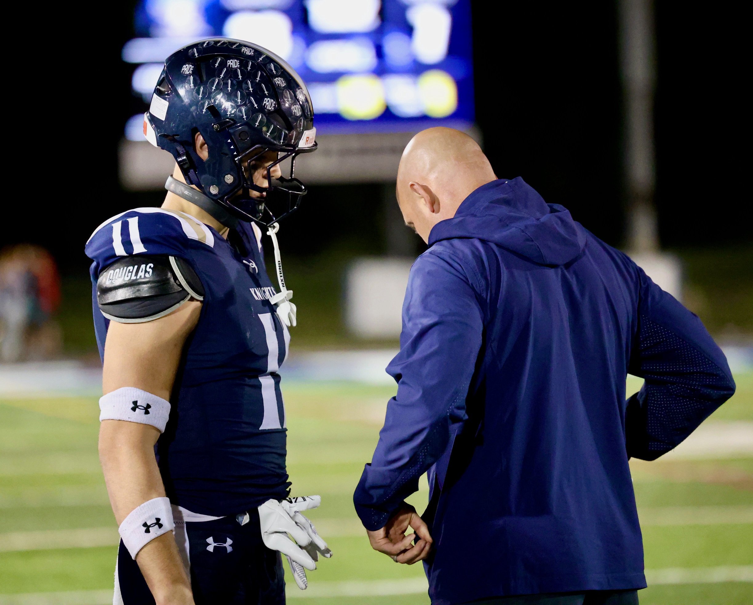 IC Catholic football (Elmhurst, IL) coach Matt Bowen (right) talks to his son, Grant Bowen, during a high school football game.
