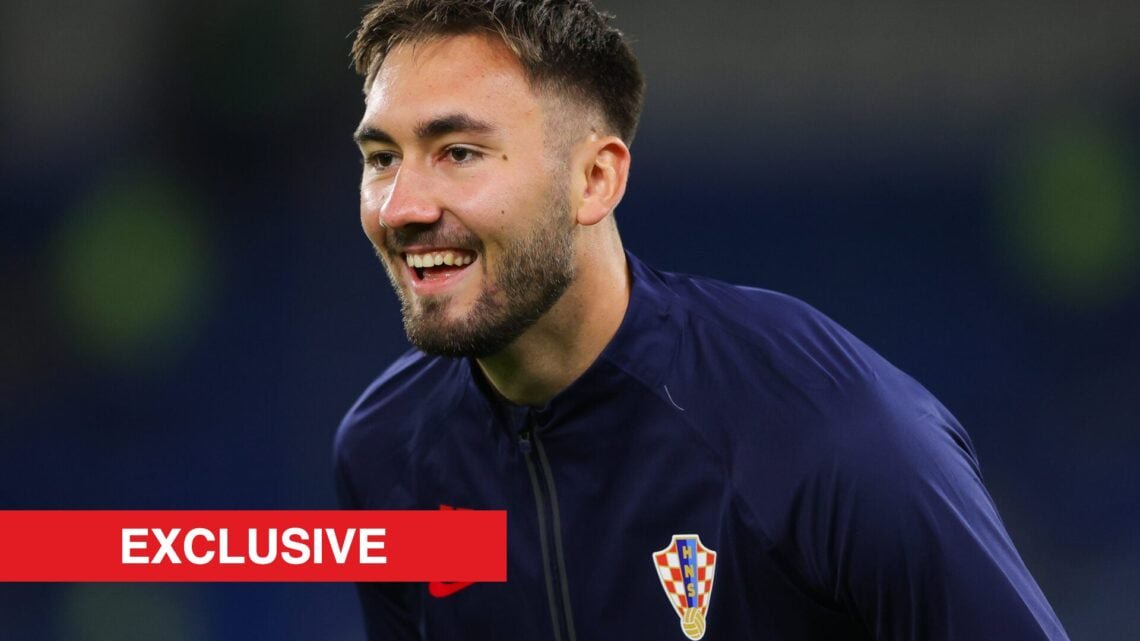 Croatia striker Dion Drena Beljo with the exclusive banner.
