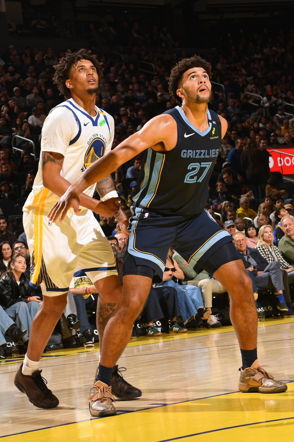 Yaxel Lendeborg of the Golden State Warriors and Cameron Boozer of the Memphis Grizzlies battle during a game.