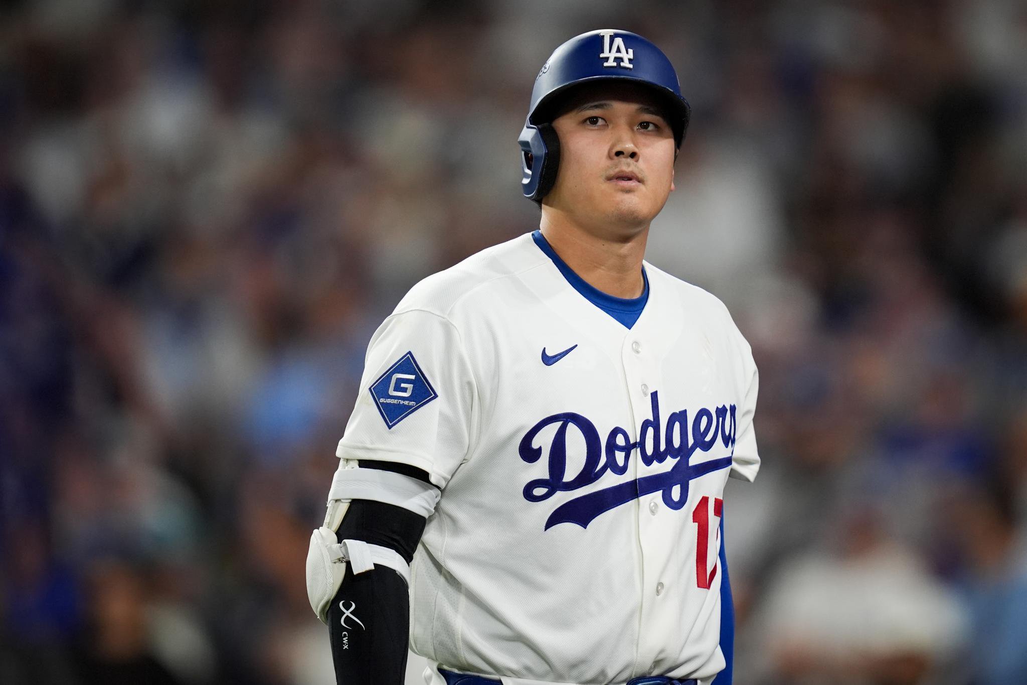 Los Angeles Dodgers designated hitter Shohei Ohtani walks to the dugout after striking out.
