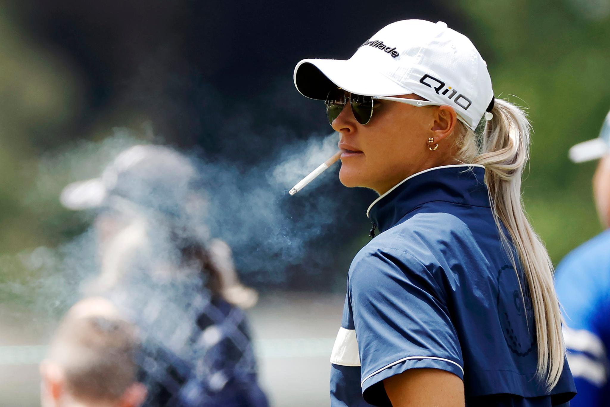Charley Hull of England smokes a cigarette on the 9th tee during the first round of the U.S. Women's Open Presented by Ally at Lancaster Country Club on May 30, 2024 in Lancaster, Pennsylvania. 