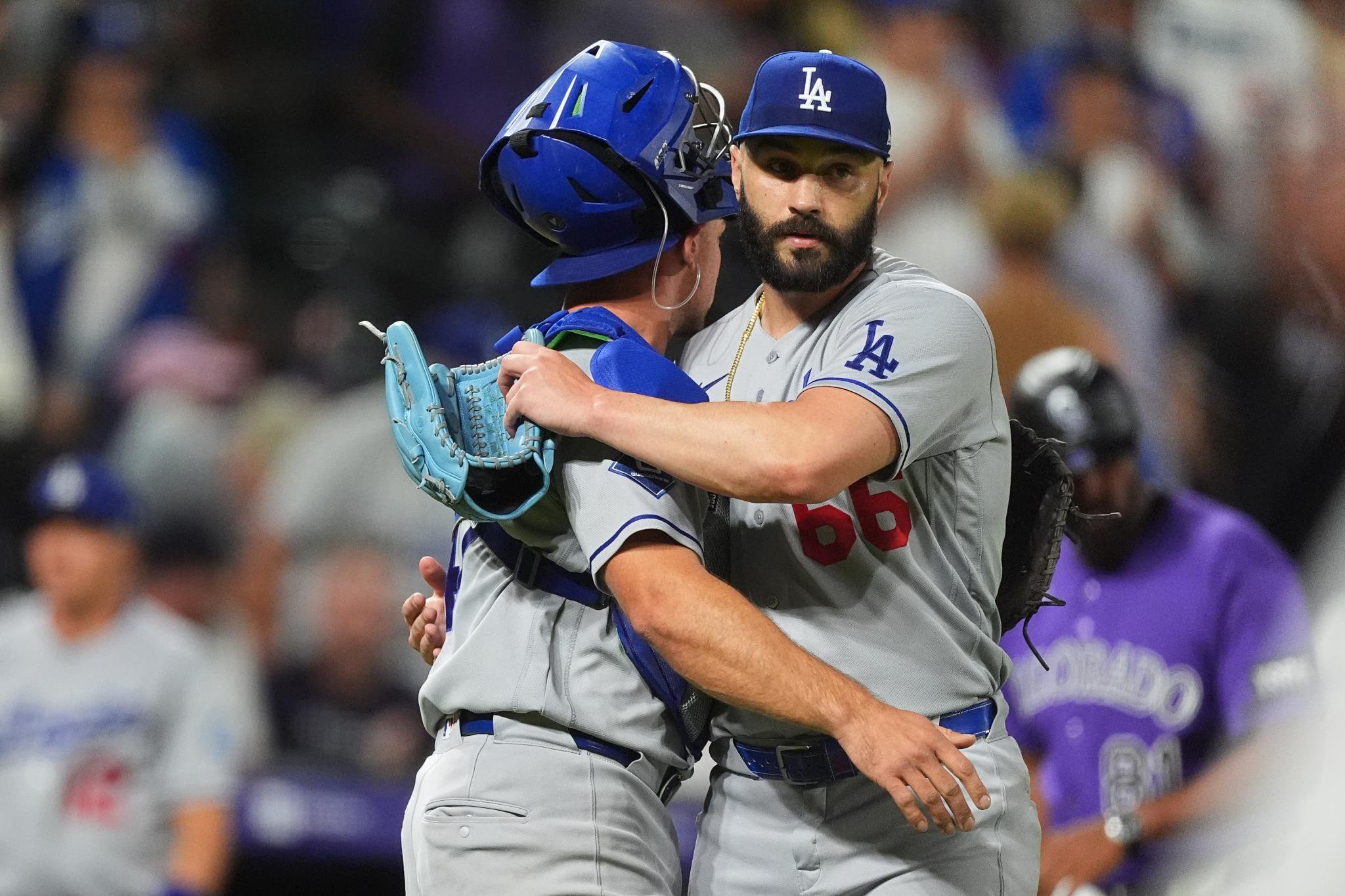 Los Angeles Dodgers catcher Ben Rortvedt, left, congratulates relief pitcher Tanner Scott after defeating the Colorado Rockies