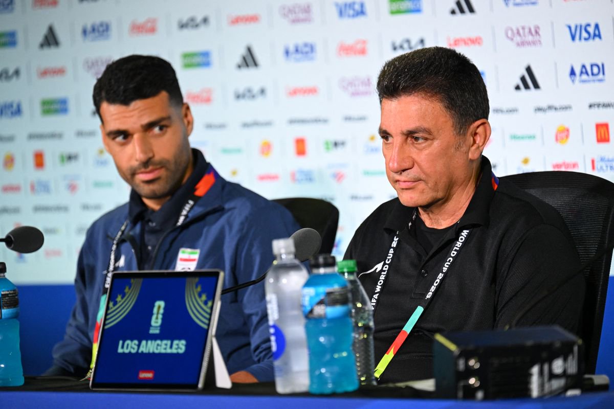 Iran's head coach Amir Ghalenoei speaking to the media alongside Mehdi Taremi
