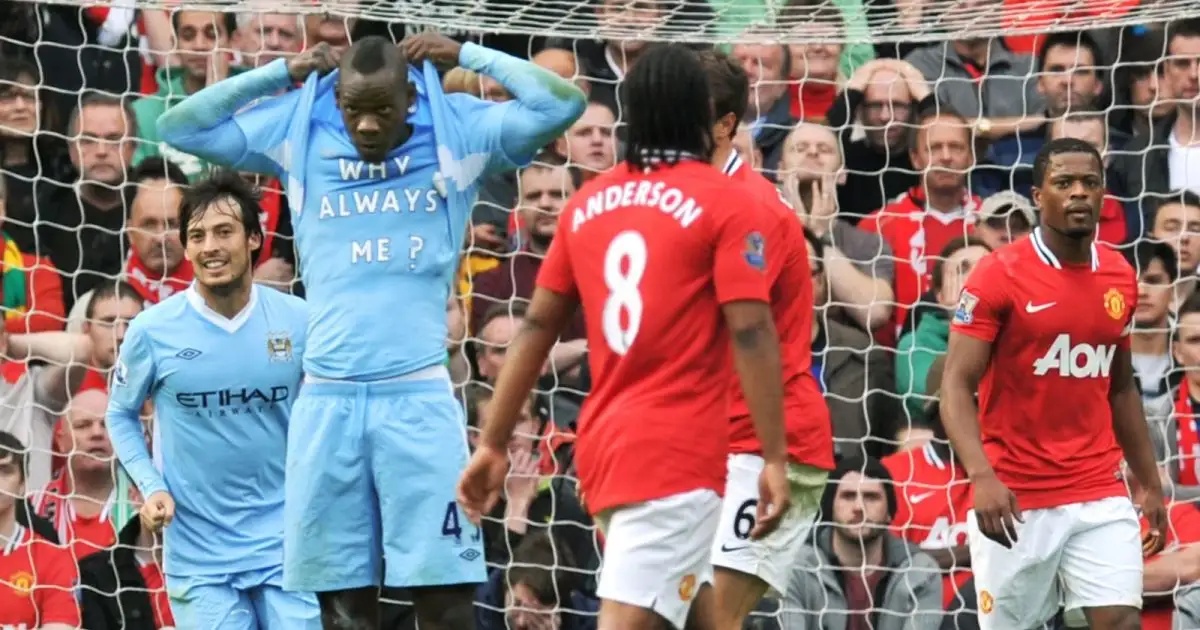 Mario Balotelli unveils his Why Always Me? t-shirt while celebrating his goal in Manchester City's 6-1 Premier League win over Manchester United at Old Trafford, Manchester, 23 October 2011.
