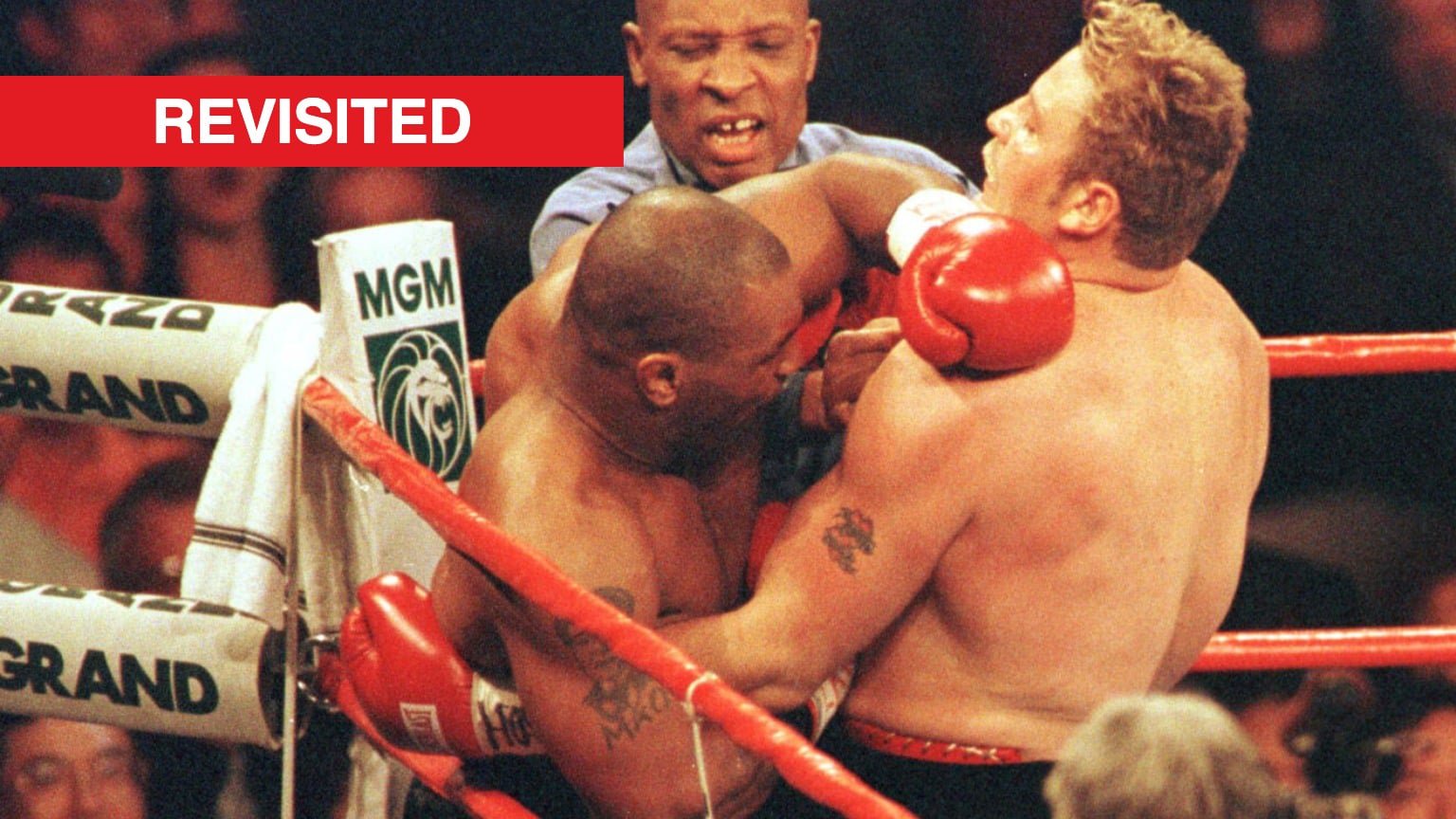 Referee steps in to seperate Mike Tyson and Francois Botha during their fight in 1999.