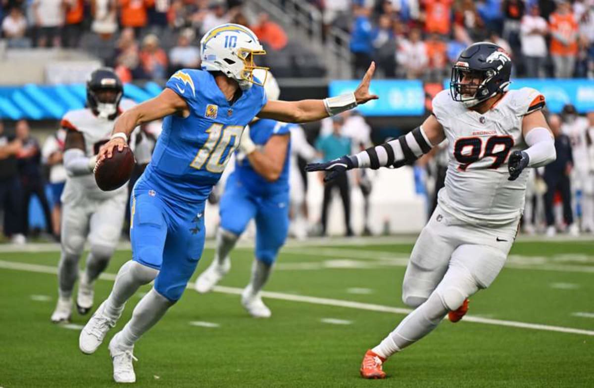 Oct 11, 2026; Inglewood, California, USA; Los Angeles Chargers quarterback Justin Herbert (10) is pressured by Denver Broncos defensive end Zach Allen (99) during the second half at SoFi Stadium. © William Liang-Imagn Images