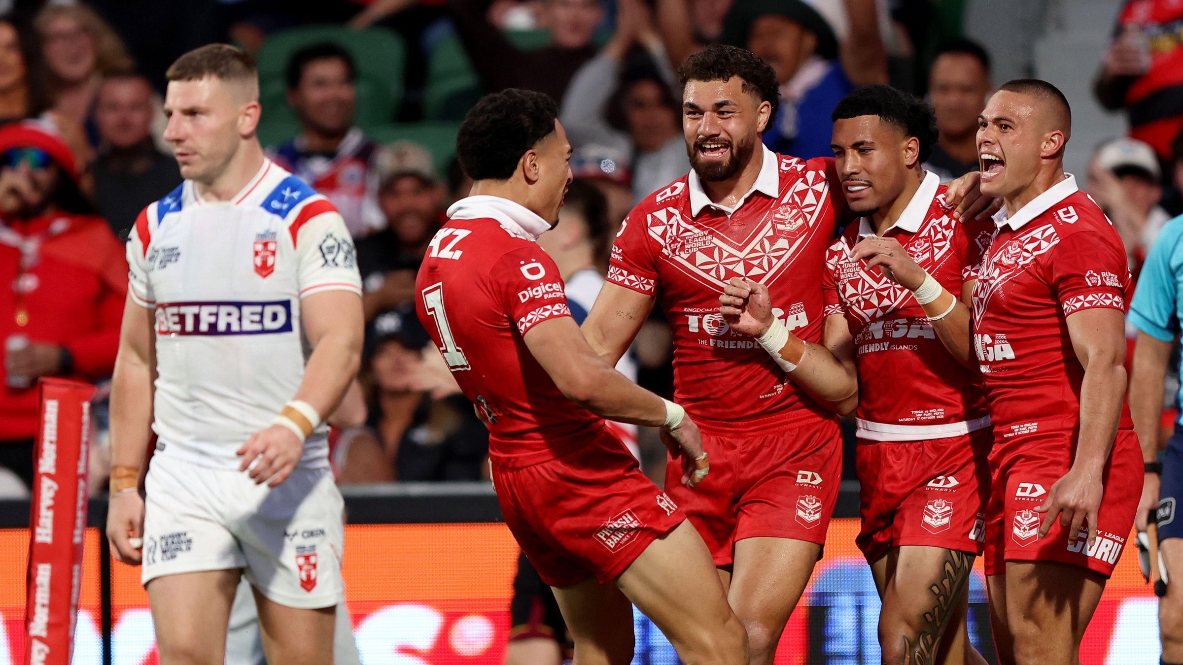 George Williams looks dejected as Tonga celebrate