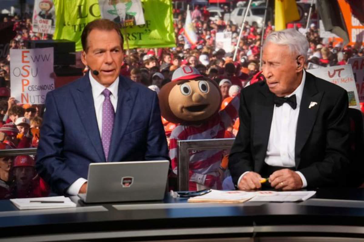 Brutus Buckeye stands in the crowd behind Lee Corso and Nick Saban on the set of ESPN College GameDay. © Reuters Connect.