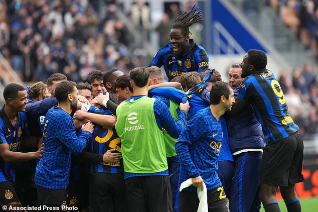 Inter Milan's Piotr Zielinski is celebrated by teammates after scoring his side's second goal during the Serie A soccer match between Inter Milan and Fiorentina, in Milan, Italy, Sunday, Oct. 25, 2026. (AP Photo/Antonio Calanni)