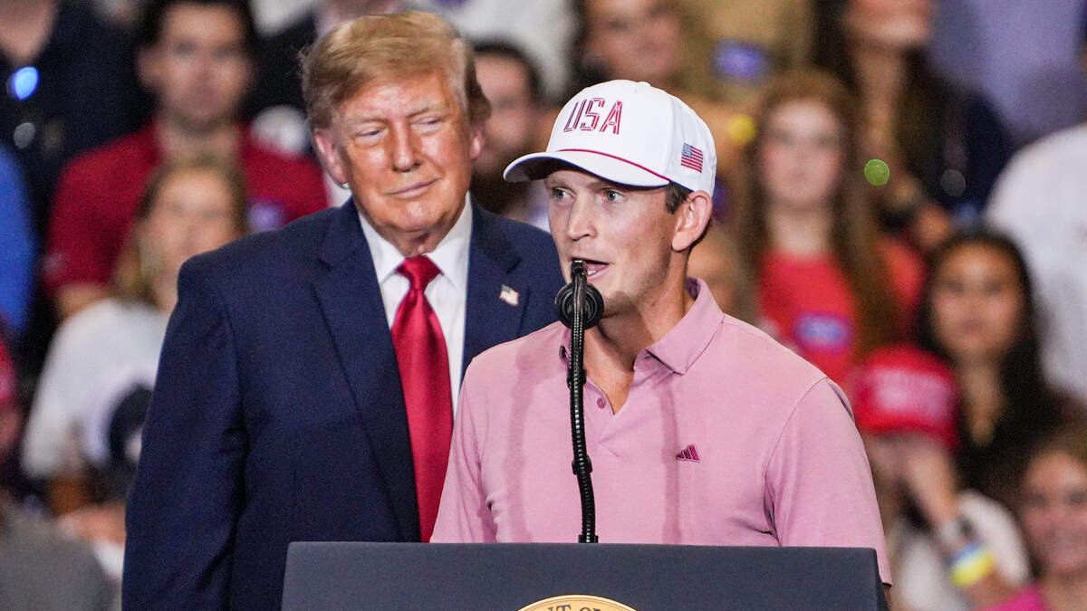 Former Clemson men’s golfer and current PGA Tour pro Jacob Bridgeman joins U.S. President Donald J. Trump on stage during his speech at a rally at the Clemson University T. Ed Garrison Livestock Arena in Pendleton.