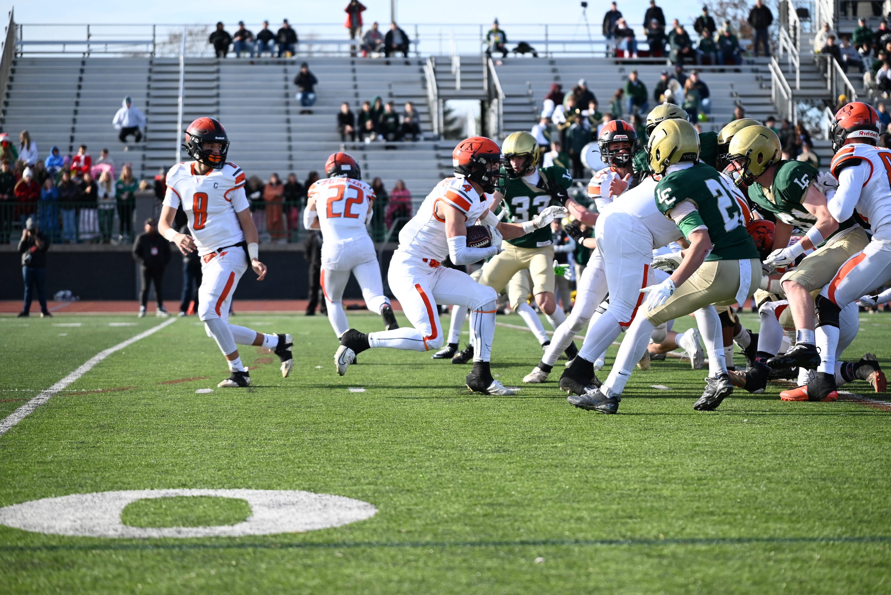 Almont's Brody Corneau (4) carries the ball during a Division 6 state semifinal against Jackson Lumen Christi at Wildcat Stadium in Novi on Saturday, Nov. 22, 2025.
